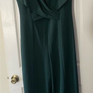 A crossover bodice elegantly defines this wide-leg jumpsuit from Calvin Klein !